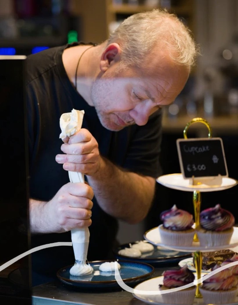 Roderick piping cream onto a dessert at Sweet Baking Mama